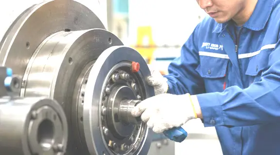 Maintenance engineer inspecting bearings using a vibration sensor